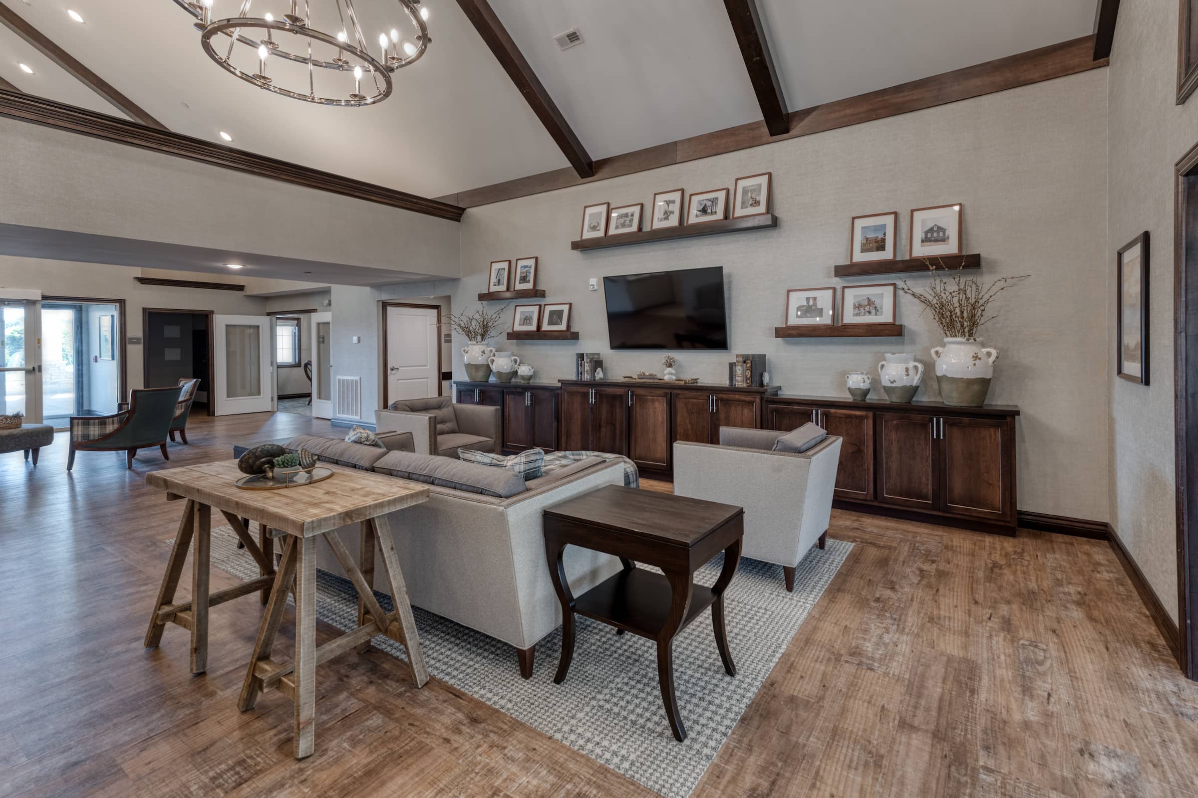 Staged TV viewing area with a wall-mounted screen and built-in cabinets